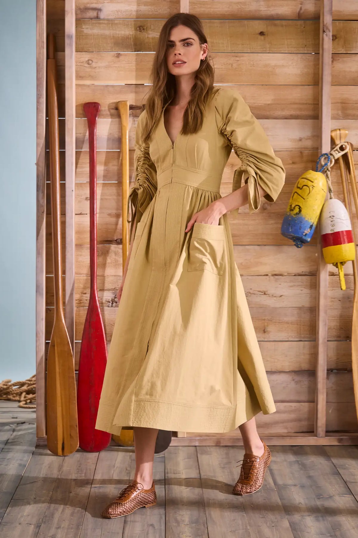 V-neck midi dress with a fitted bodice, full skirt, elbow-length sleeves finish with ties.