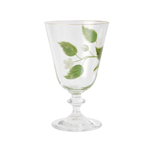 A product photograph of an elegant, clear glass wine or water glass with a footed stem and a fine gold rim, set against a clean, light gray background. The front of the glass is delicately hand-painted with a botanical design featuring a slender green branch with leaves and small white blossoms.