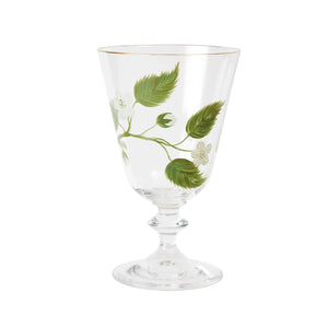 A product photograph of an elegant, clear glass wine or water glass with a footed stem and a fine gold rim, set against a clean, light gray background. The front of the glass is delicately hand-painted with a botanical design featuring a slender green branch with leaves and small white blossoms.