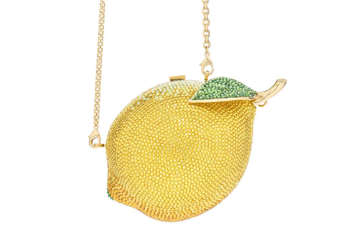 Close-up view of Lemon Citron Clutch showcasing its crystal-embellished lemon shape and shoulder chain against a white background