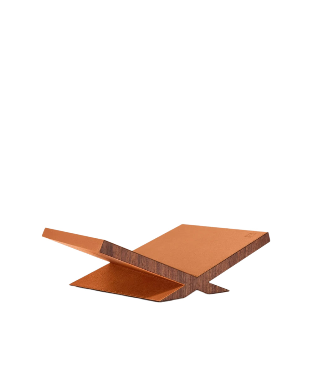 Three-quarter view of Culture Classic Bookstand in camel leather showing tilted walnut base and pebbled leather top