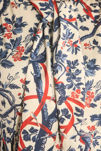 The Lila Dress is a mini with a tie neckline, long sleeves with button cuffs and a color block hem. 