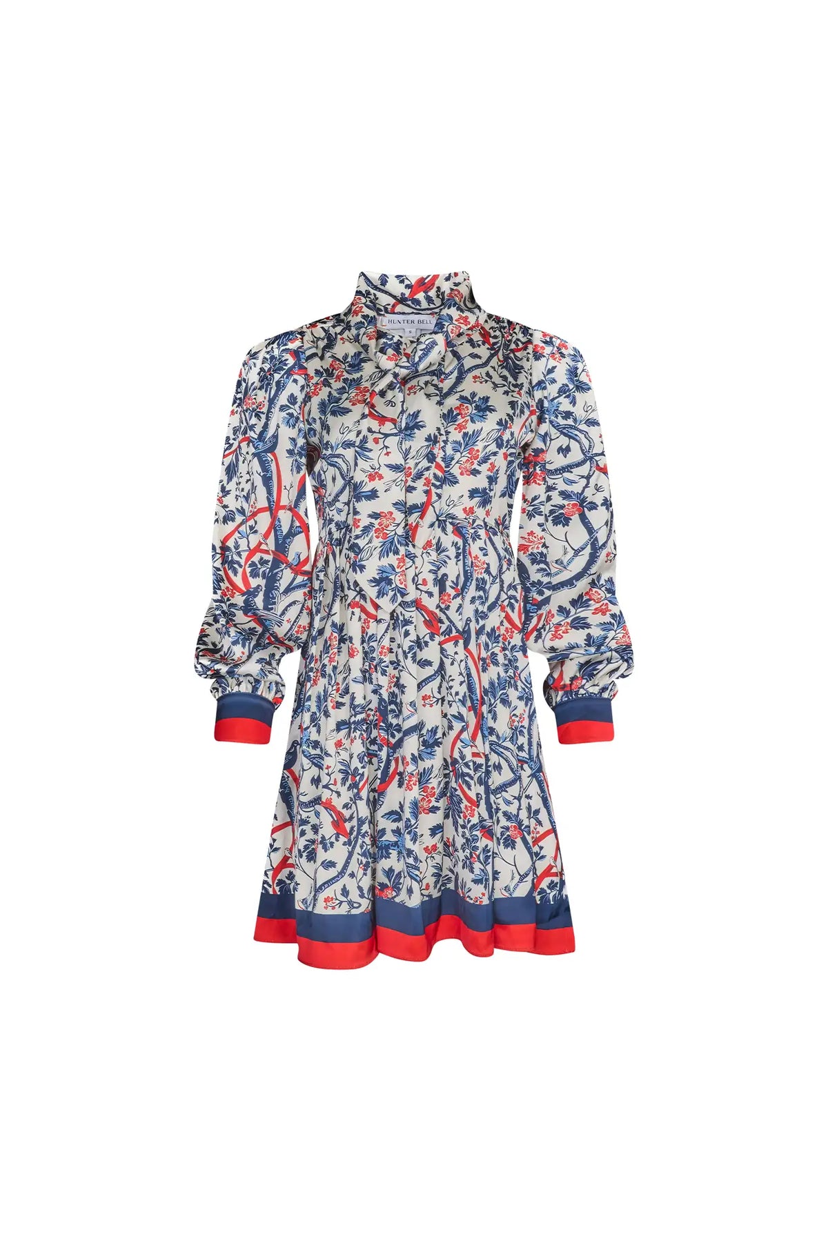 The Lila Dress is a mini with a tie neckline, long sleeves with button cuffs and a color block hem. 