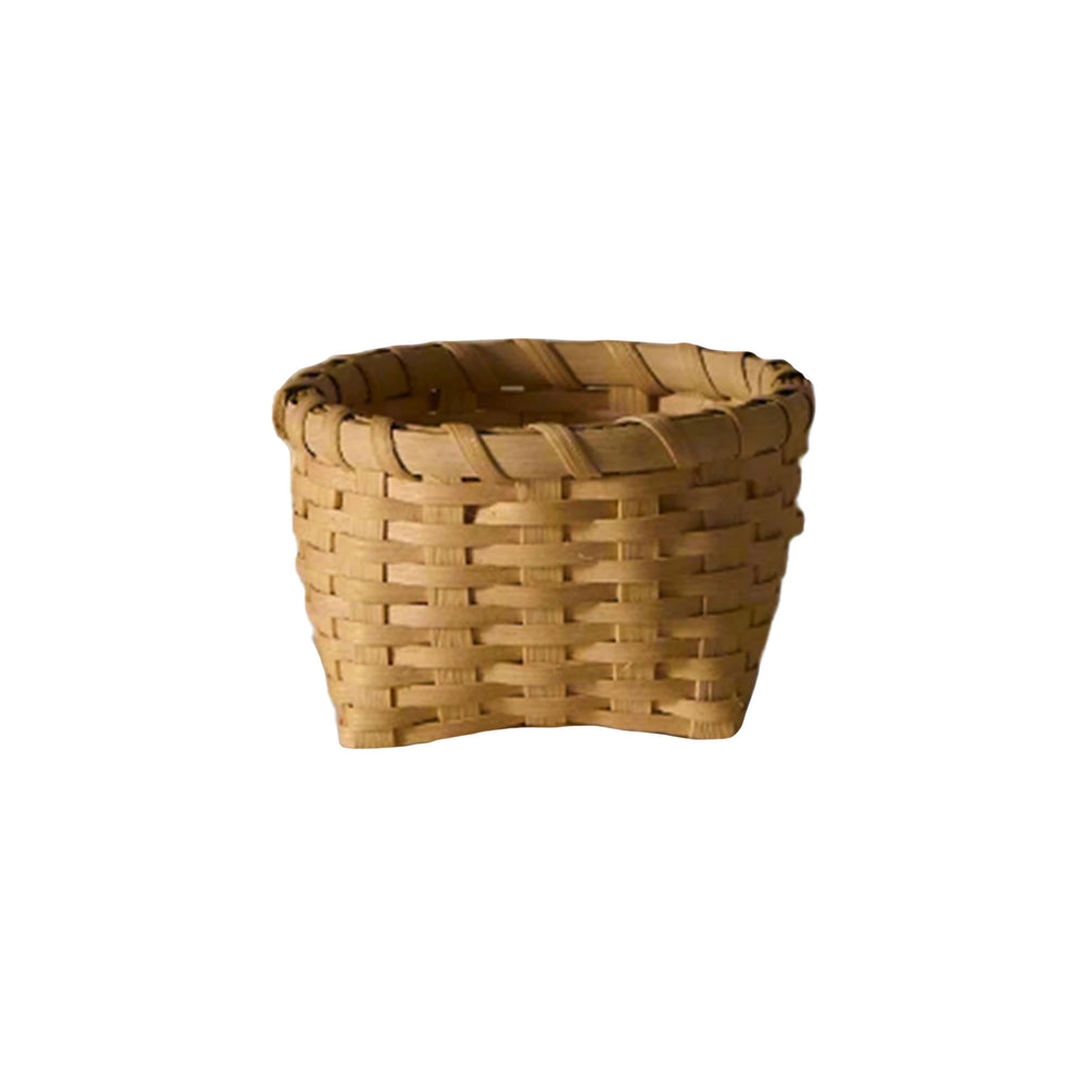 Front view of Little Love Basket showcasing woven natural rattan construction and cathead corners on white background