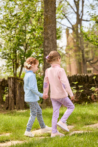 Little English traditional children's clothing.  Long sleeve Hastings polo in light pink with ruffle collar and purple floral detailing. Paired with Purple floral leggings for little girls.  Light blue Hastings polo with green floral detail paired with green floral leggings.