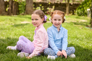 Little English traditional children's clothing.  Long sleeve Hastings polo in light pink with ruffle collar and purple floral detailing. Paired with Purple floral leggings for little girls.  Light blue Hastings polo with green floral detail paired with green floral leggings.