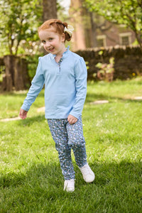 Little English traditional children's clothing.  Long sleeve Hastings polo in light blue with ruffle collar and green floral detailing. Paired with green floral leggings for little girls.  