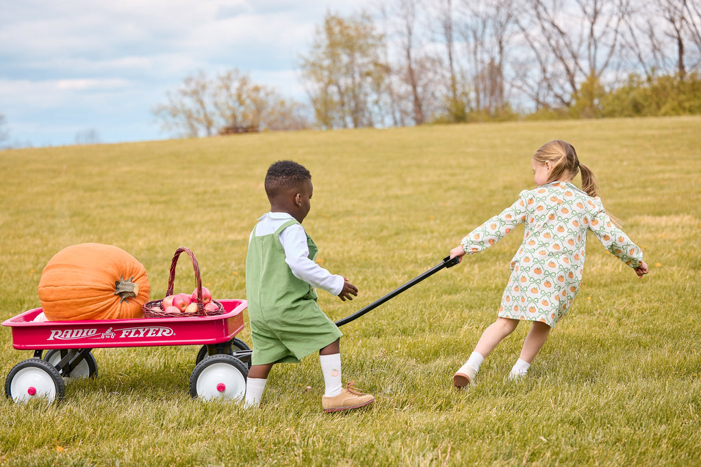 Little English classic children's clothing, knit white top with peter pan collar and pumpkin pinpoint on each side, jack shortall in watercress corduroy for boy,  and evelyn dress in pumpkin trellis print for girl, coordinating outfits for fall 