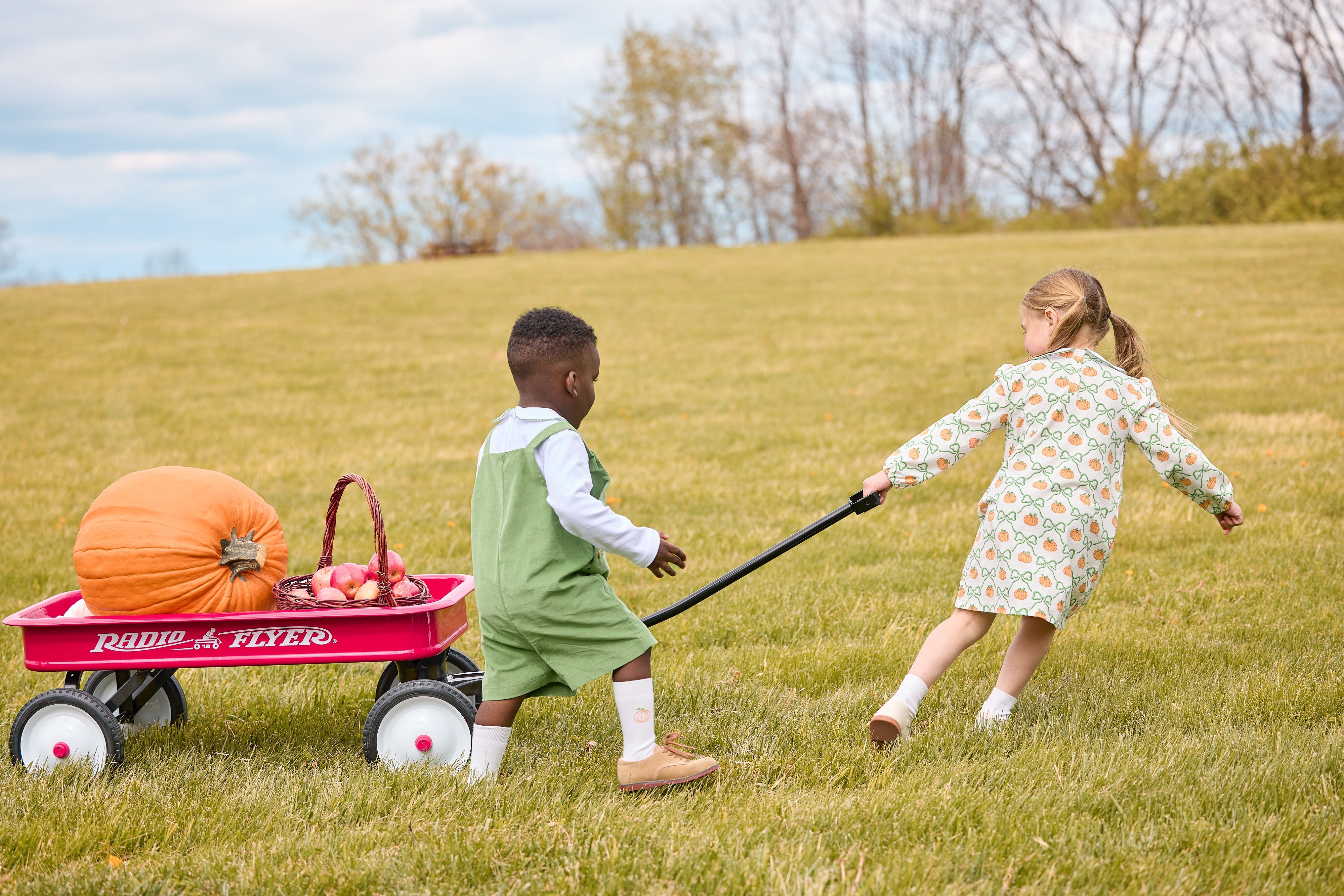 Little English classic children's clothing, knit white top with peter pan collar and pumpkin pinpoint on each side, jack shortall in watercress corduroy for boy,  and evelyn dress in pumpkin trellis print for girl, coordinating outfits for fall 