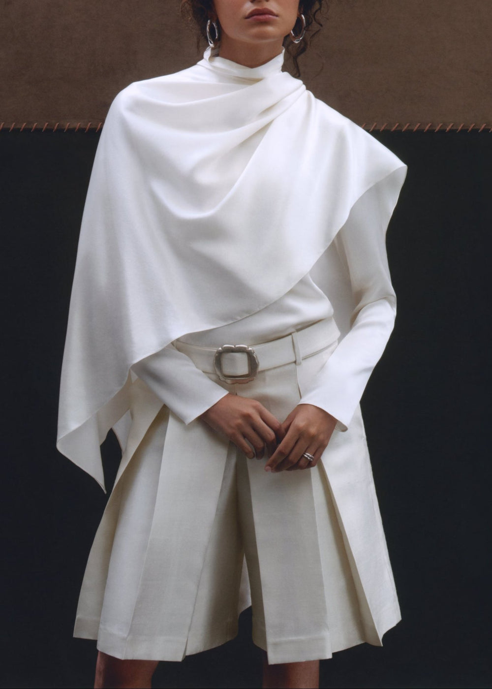 Front view of Olivia Scarf Top showcasing its draped fit and white stretch silk charmeuse on a model against a dark background