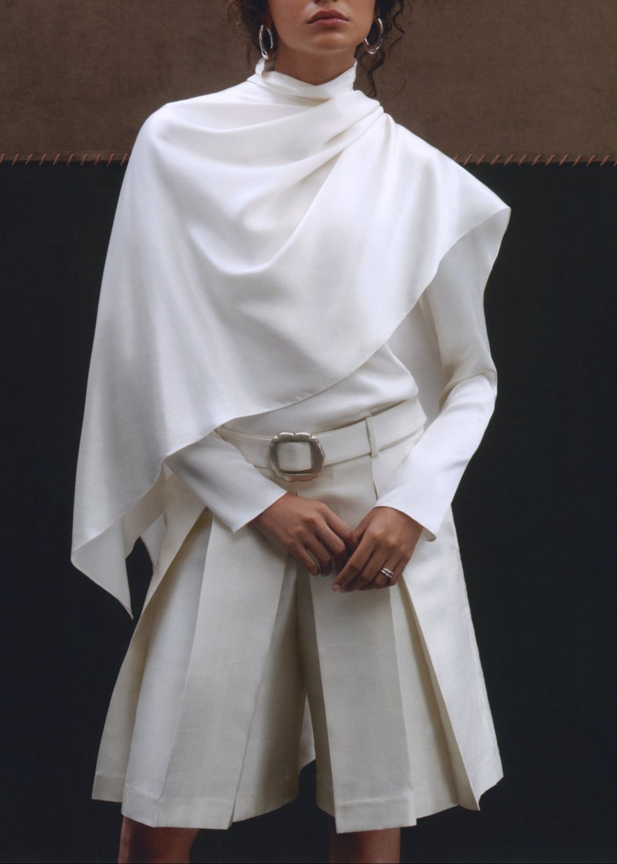 Front view of Olivia Scarf Top showcasing its draped fit and white stretch silk charmeuse on a model against a dark background