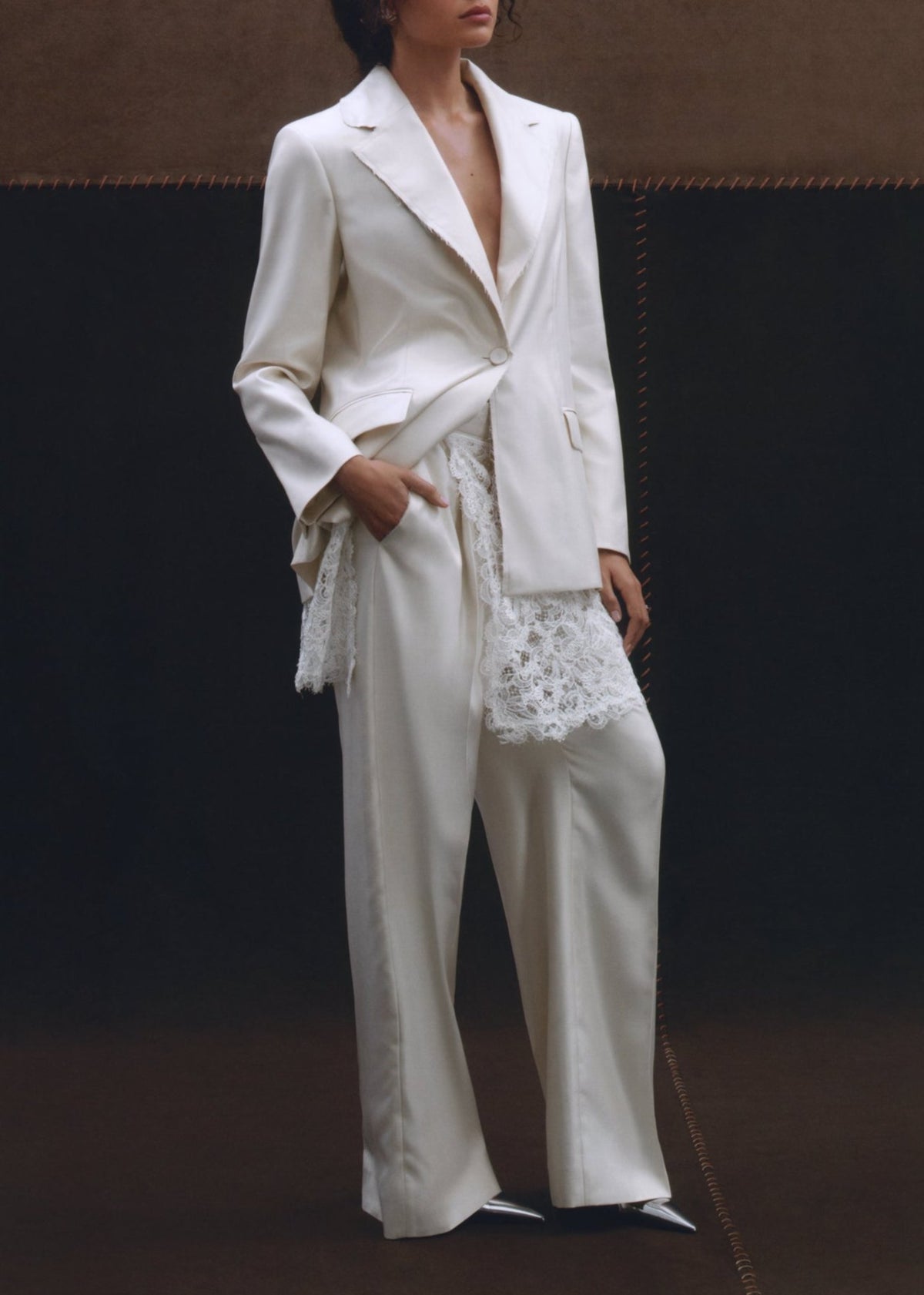 Front view of ivory Georgianna Pant showcasing wide-leg tailoring on a model against a dark backdrop