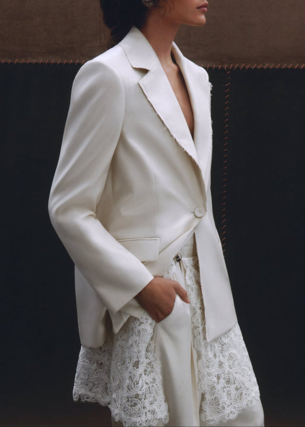 Front view of the Georgianna Jacket showcasing raw edge detailing and single button closure on a model against a dark background