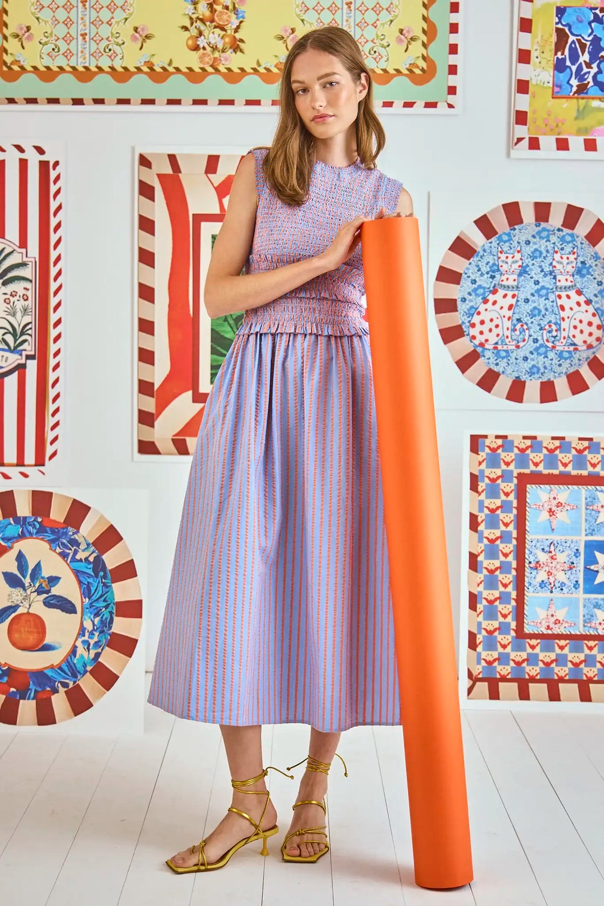 The Louise midi dress has a smocked elastic waist and bodice and a bold neon grosgrain ribbon tie.