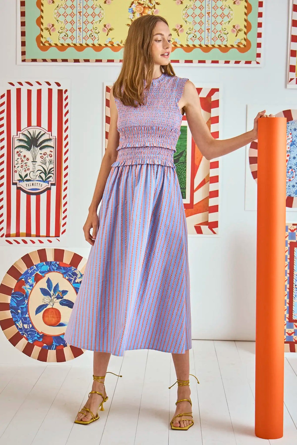 The Louise midi dress has a smocked elastic waist and bodice and a bold neon grosgrain ribbon tie.