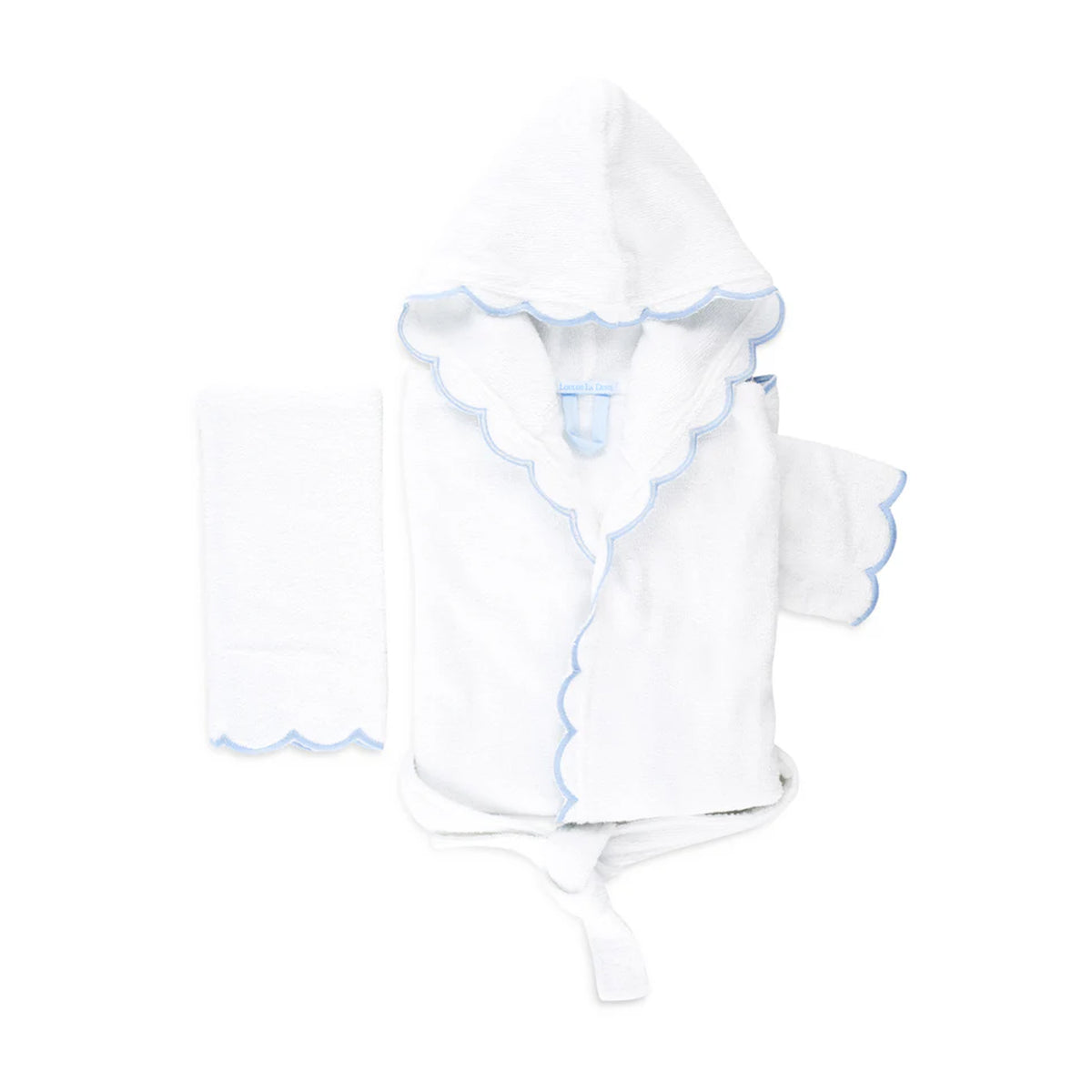 Flat lay of Loulou toddler hooded bathrobe set showing scalloped blue trim and matching washcloth on white background