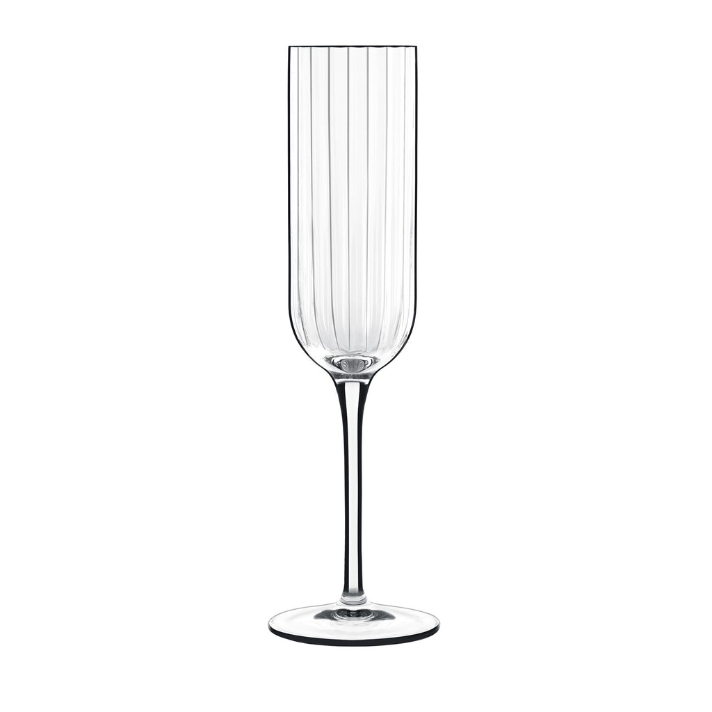Front view of Luigi Bormioli Bach Flute champagne glass showcasing its faceted bowl and slender stem on a white background