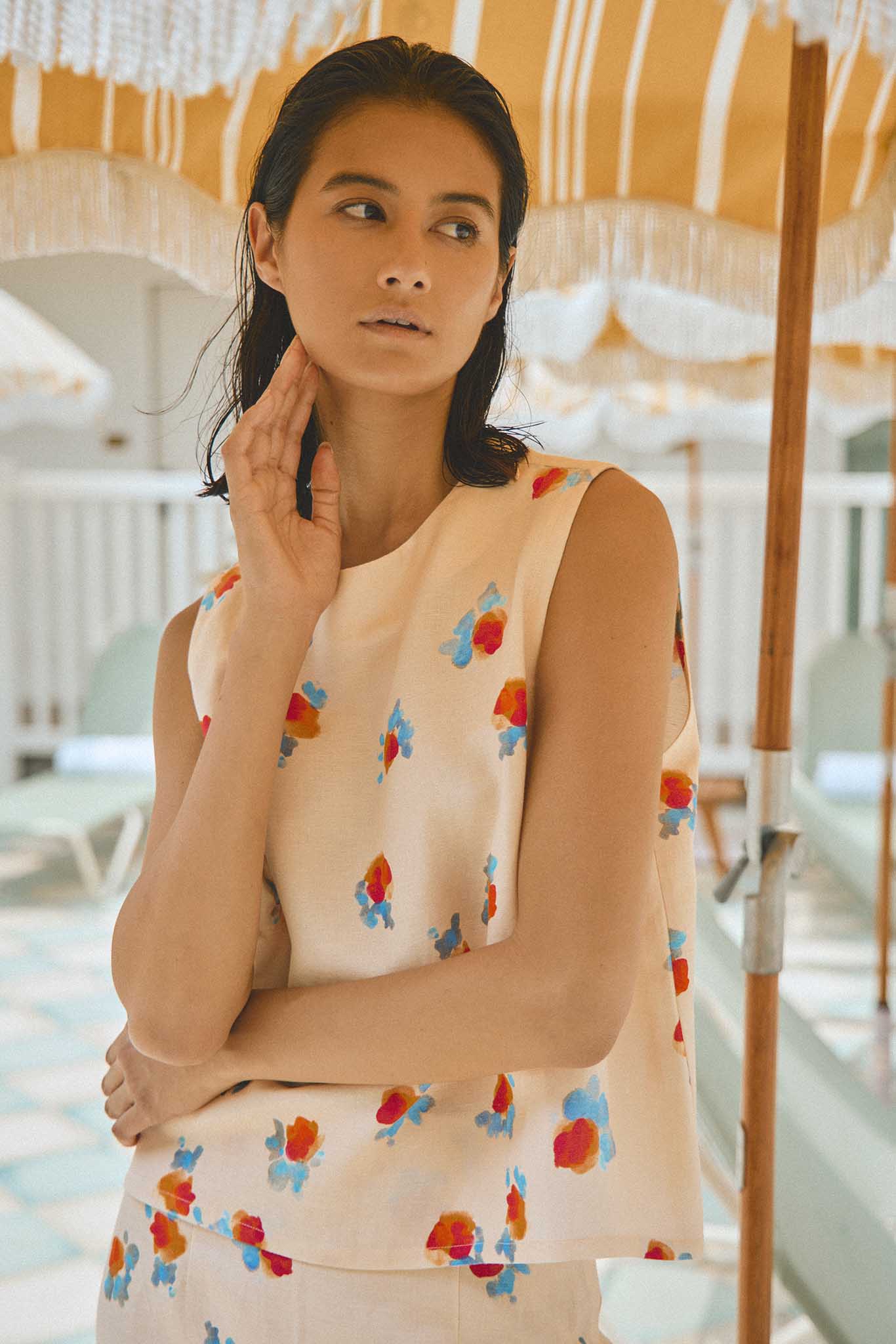 The Luna Top is a sleeveless crew neckline with subtle zipper closures along the shoulder line.