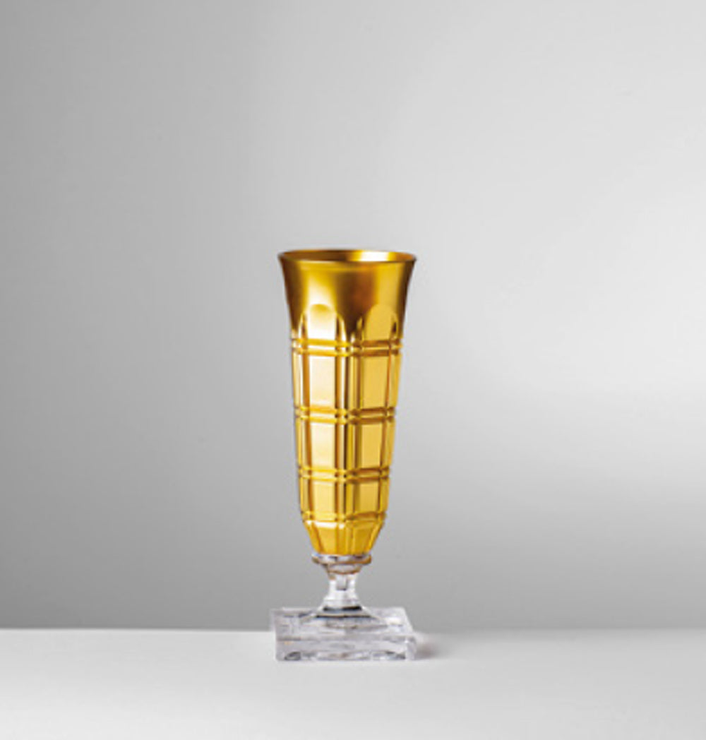 Front view of Winston acrylic champagne flute showcasing gold faceted body and clear square base on neutral gray background