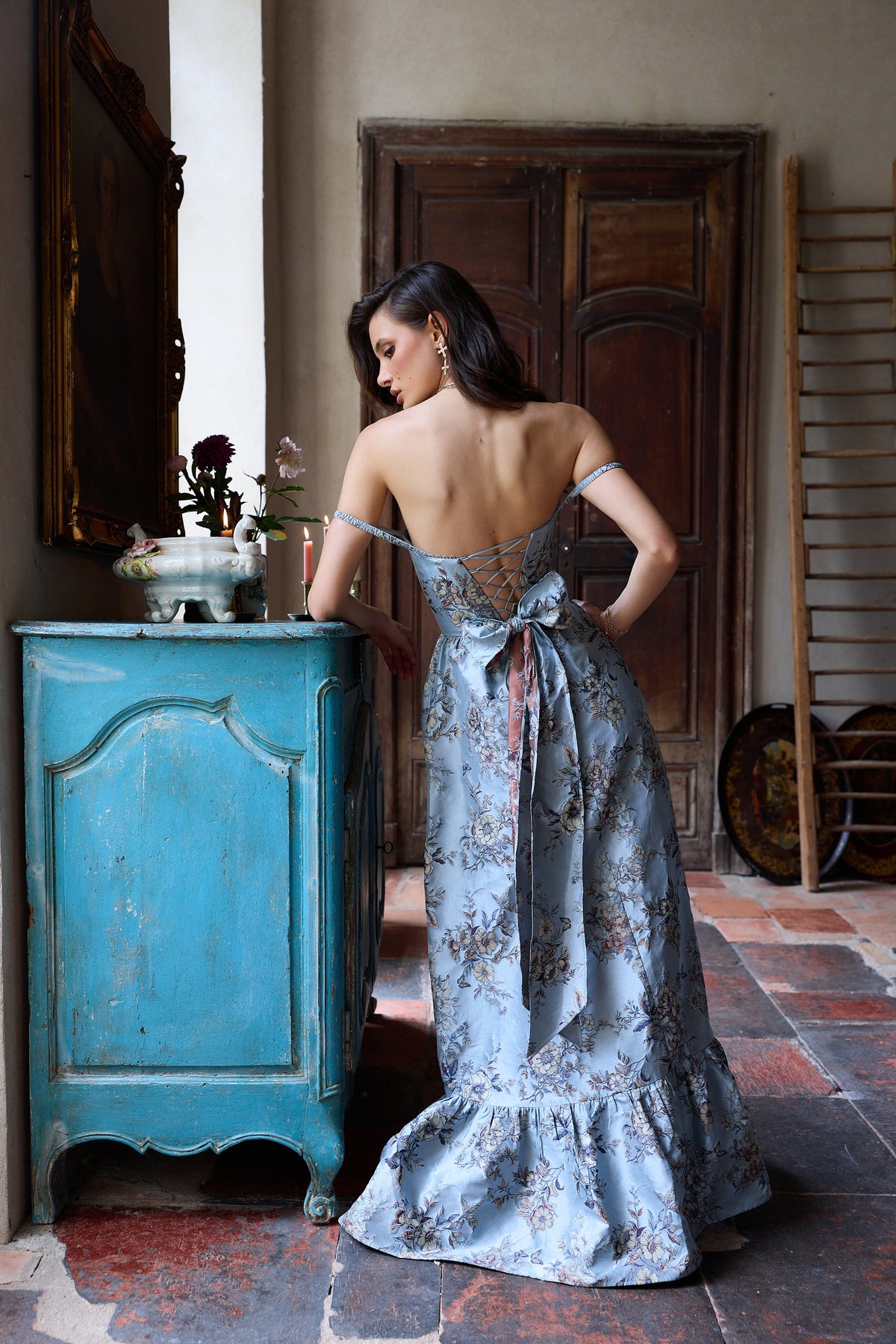 Rear view of The Margaret Dress in Light Blue Lilibet Brocade showcasing its laced corset back and floral brocade