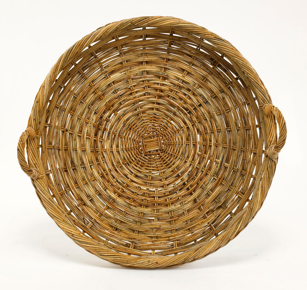 Top view of French Country large round tray showcasing woven natural rattan construction and two loop handles on white background