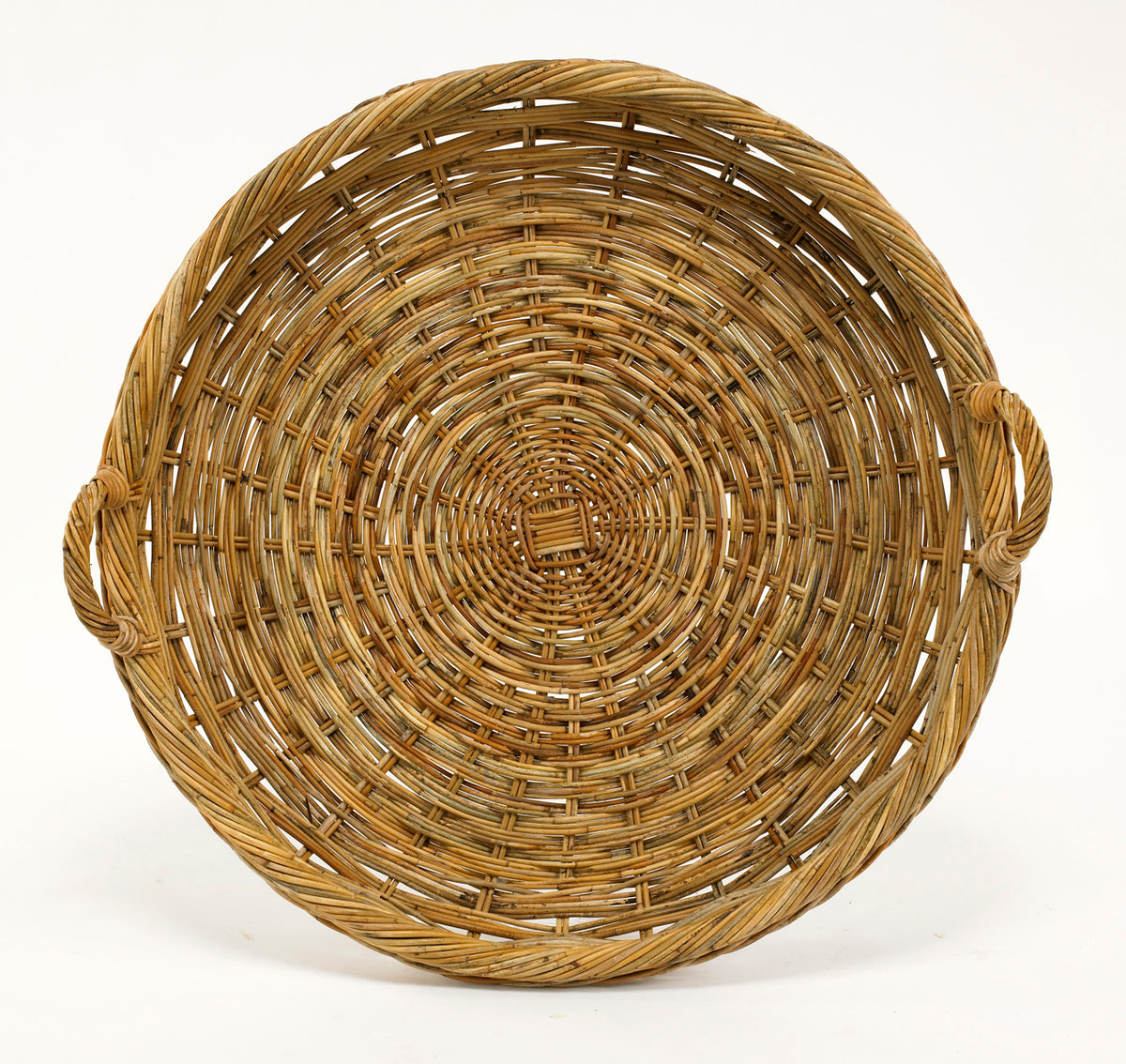 Top view of French Country large round tray showcasing woven natural rattan construction and two loop handles on white background