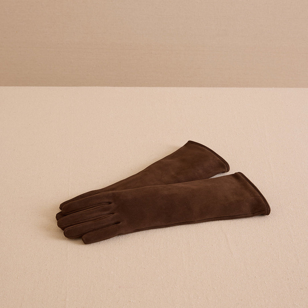 Front view of Babe 35 gloves in chocolate nubuck showcasing long length and soft nubuck finish on beige background