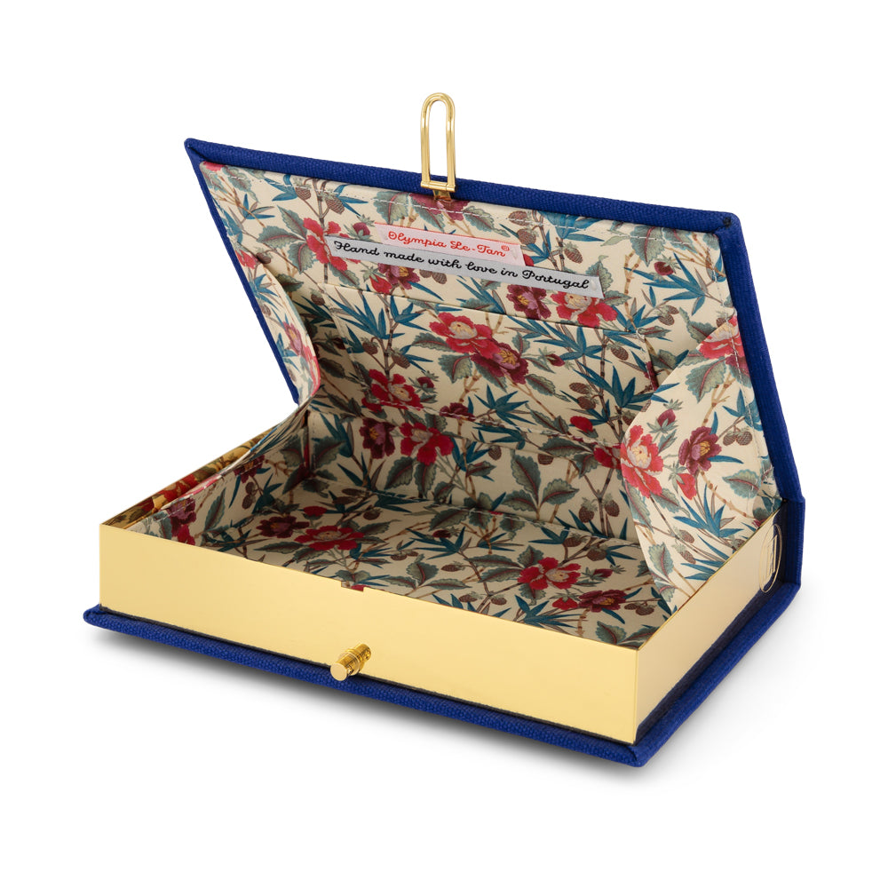 Open view of French Fries Book Clutch showing floral interior lining, gold frame, and interior label reading Hand made with love in Portugal