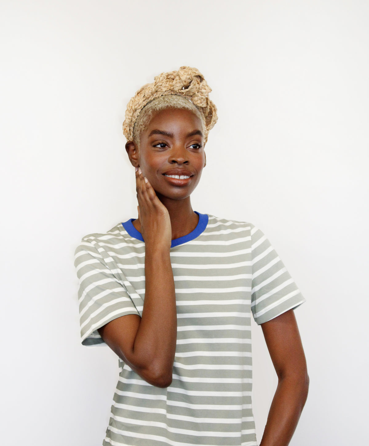 Front view of Mooring Headband showcasing braided raffia twists in a rustic tiara design on a model against a white background