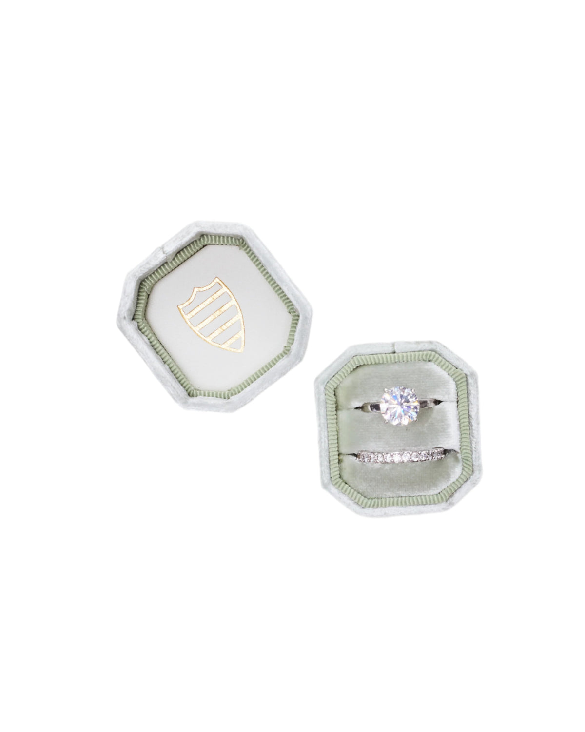 Top-down view of The Carlyle Bevel Double showing sage-green velvet octagon, gold crest, and two rings