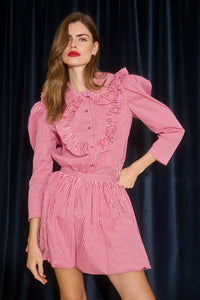 The Mae Top has a collared button front shape, ruffled yokes, and long sleeves with button cuffs. 