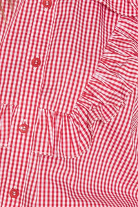 The Mae Top has a collared button front shape, ruffled yokes, and long sleeves with button cuffs. 