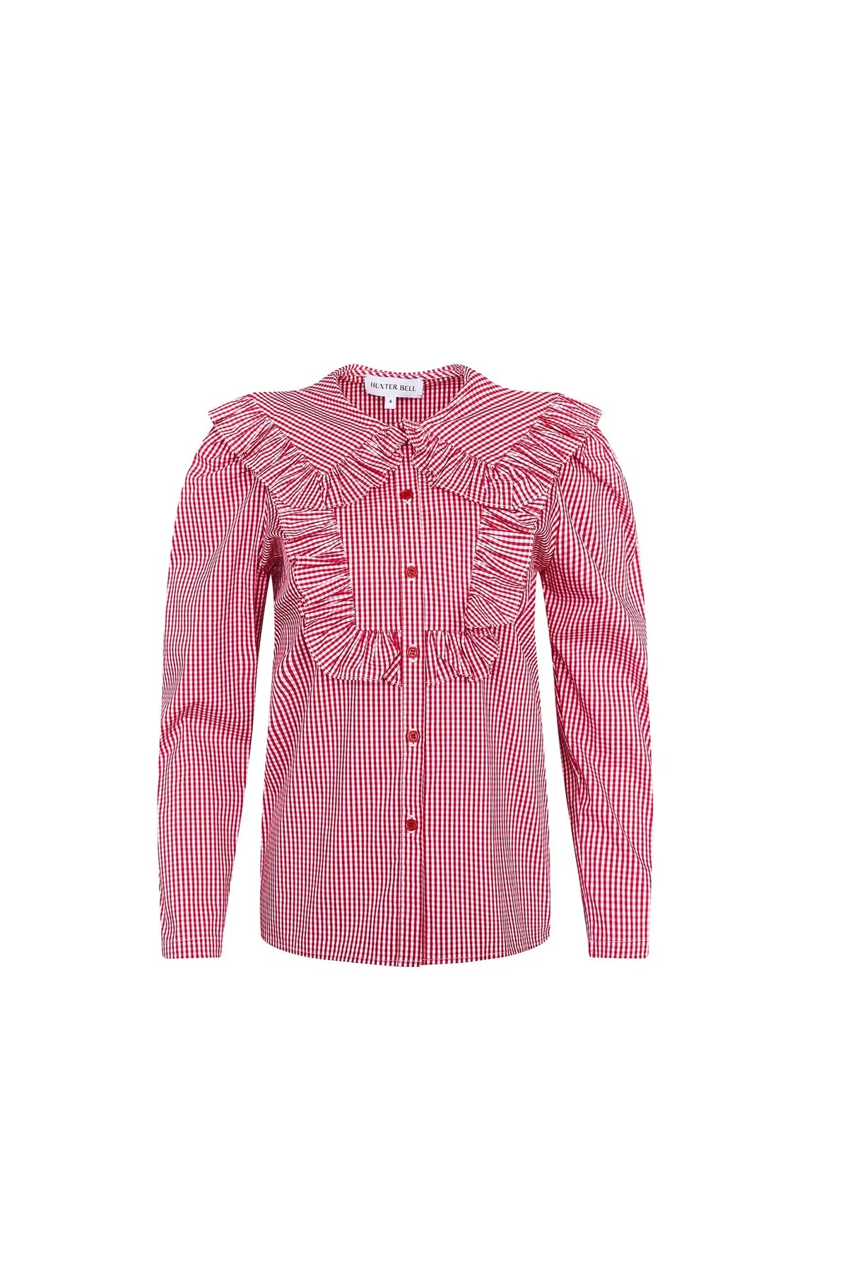 The Mae Top has a collared button front shape, ruffled yokes, and long sleeves with button cuffs. 