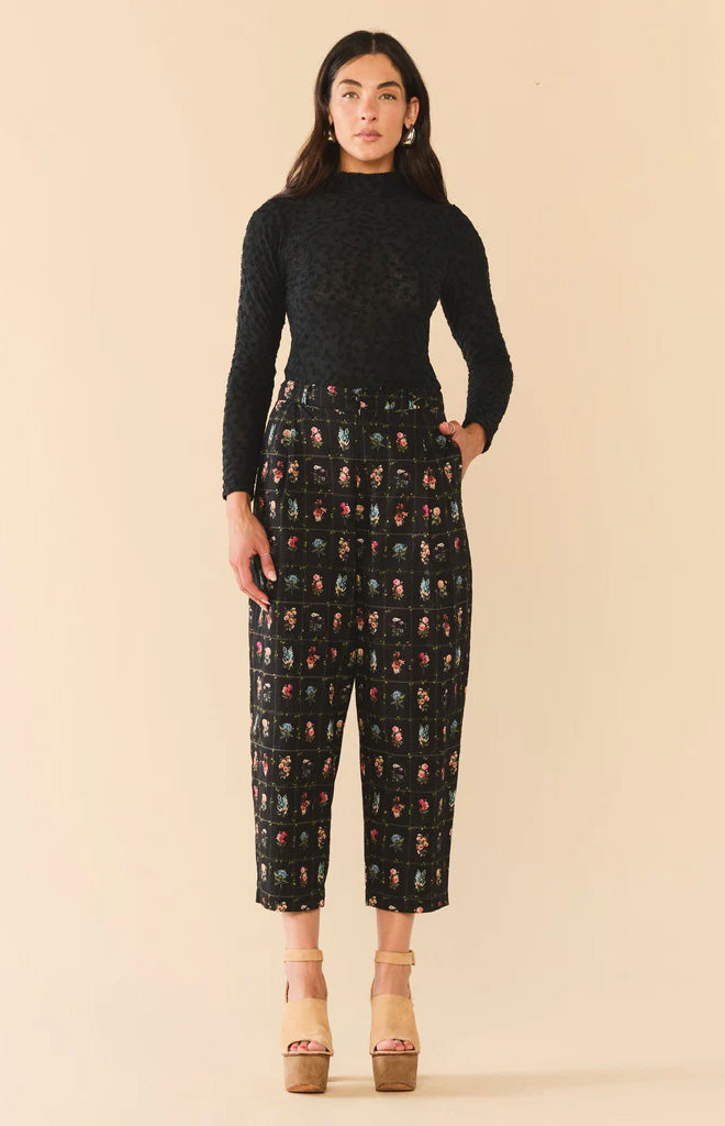 Front view of Maeve Pant in Florence Black Floral showcasing relaxed fit on a model against a beige background