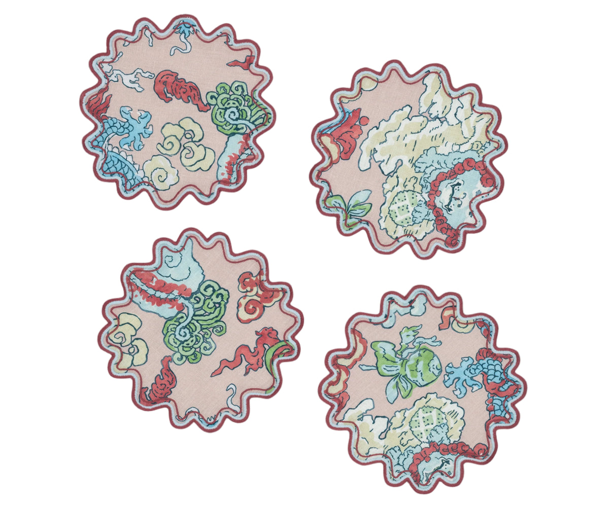 Top view of Magic Mountain cocktail napkins, set of 4, showing scalloped embroidered border and dragon print on pink linen