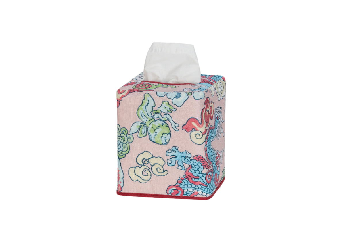 Angled view of Magic Mountain tissue box cover showing pink linen with colorful dragon and foo dog print and red trim