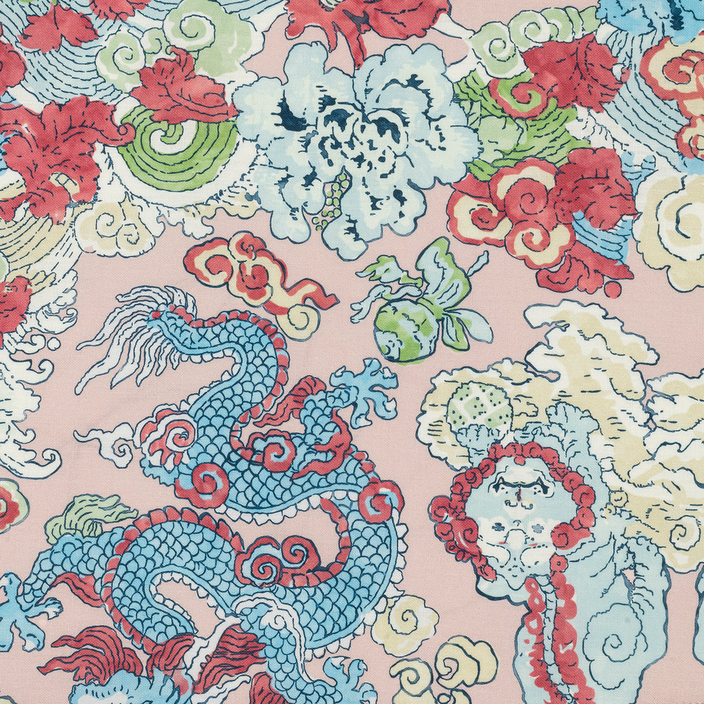 Close-up of Magic Mountain cocktail napkin showcasing blue dragon and foo dog print with red and green cloud motifs on pink background