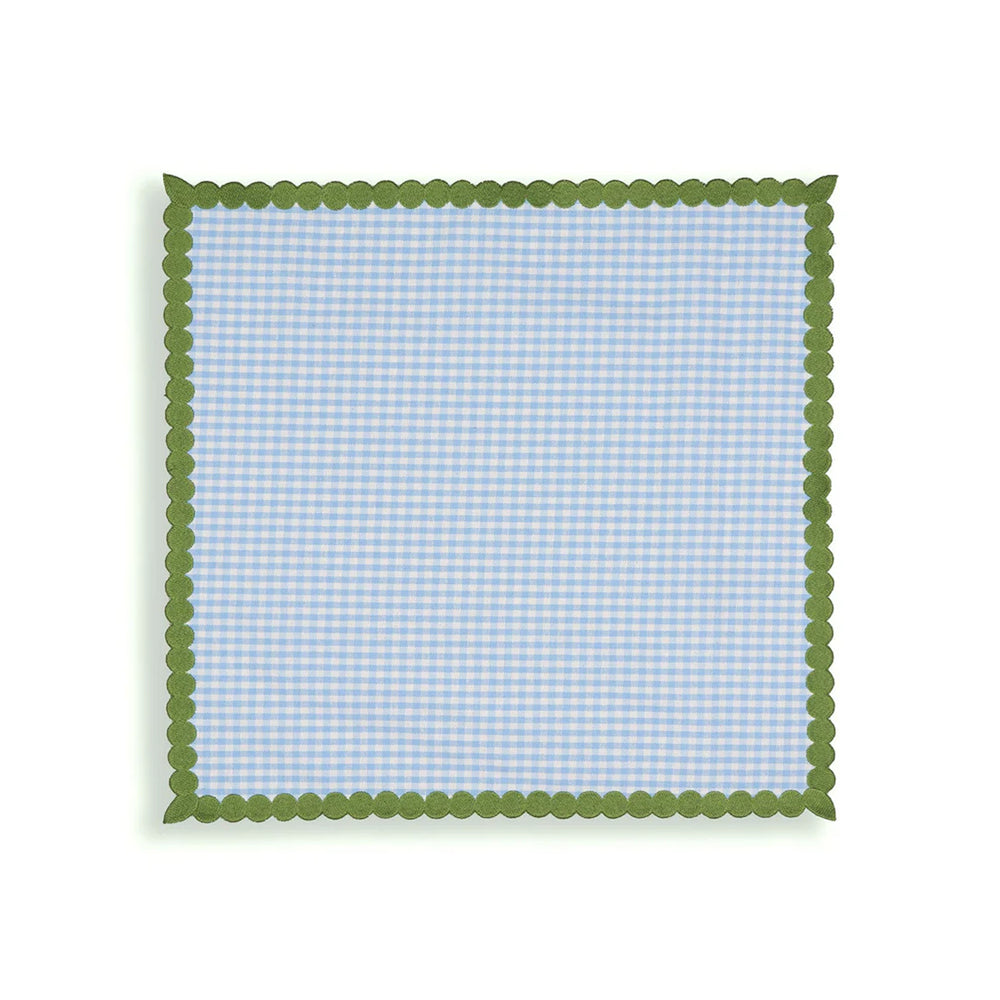 Top-down view of Maisie napkins set of 4 in blue gingham showcasing scalloped green trim on white background