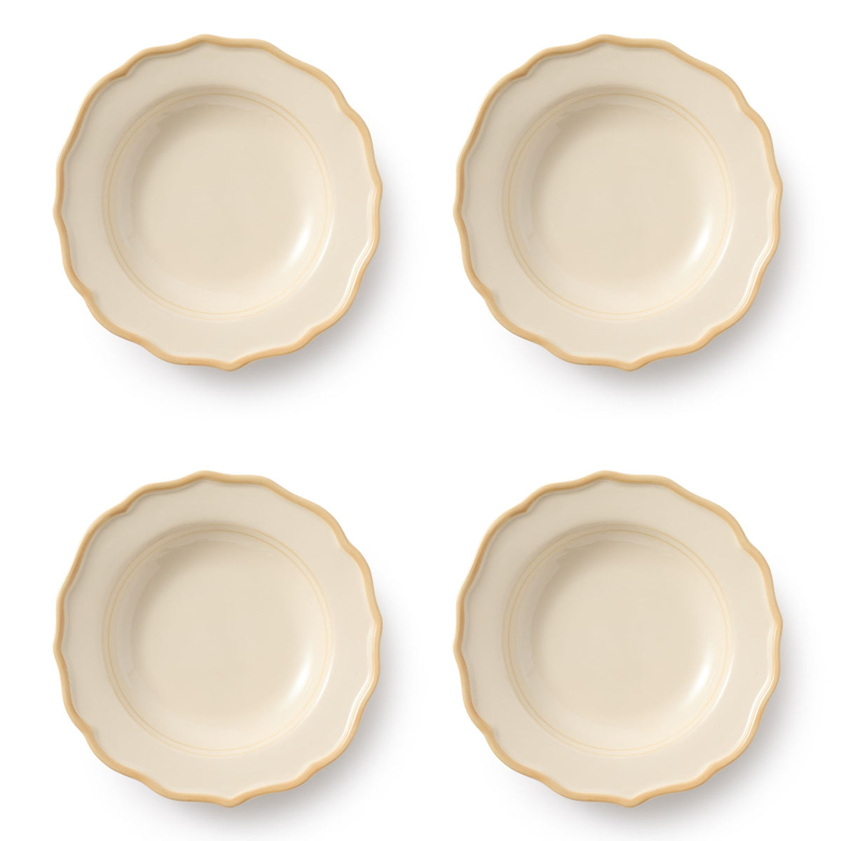 Top view of four Colette Pasta Bowls showcasing scalloped edges and gold-toned rims on a white background