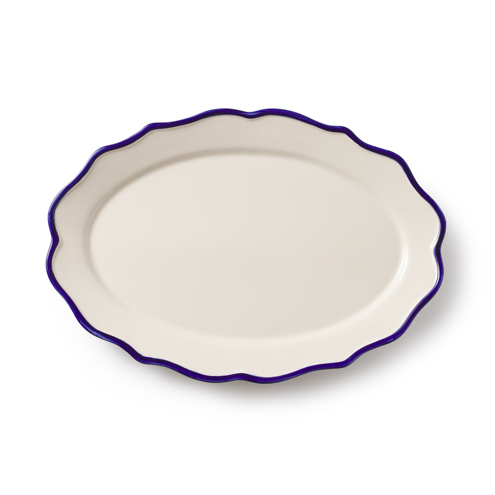 Top view of Jane oval platter showing scalloped sea-blue rim on cream ceramic against white background