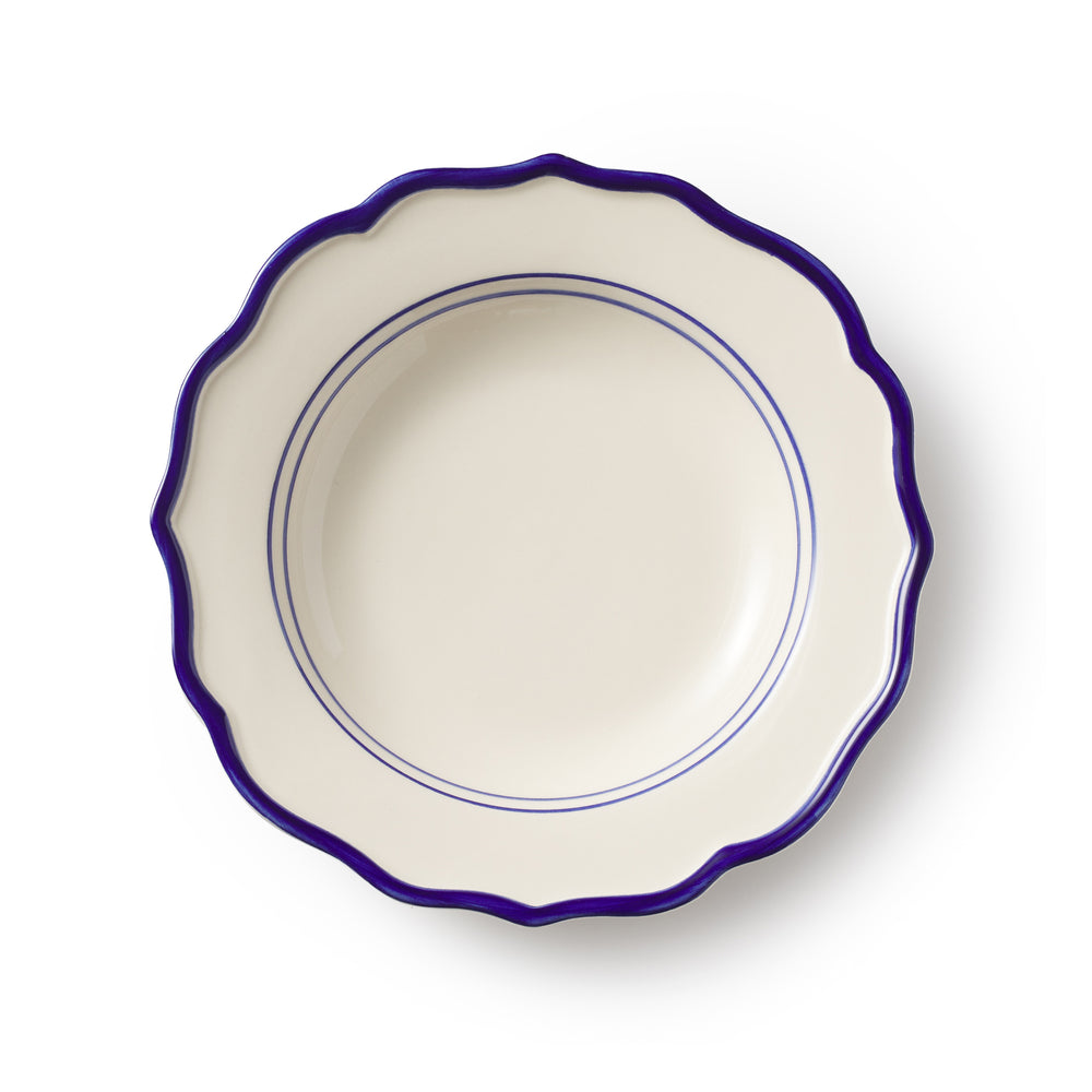 Top view of Jane Pasta Bowl showing scalloped edge and cobalt blue rim with double inner rings on a white background