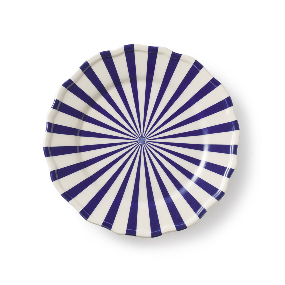 Top view of Mafalda side plate showcasing blue radiating sunburst stripes and scalloped scalloped edge on white background