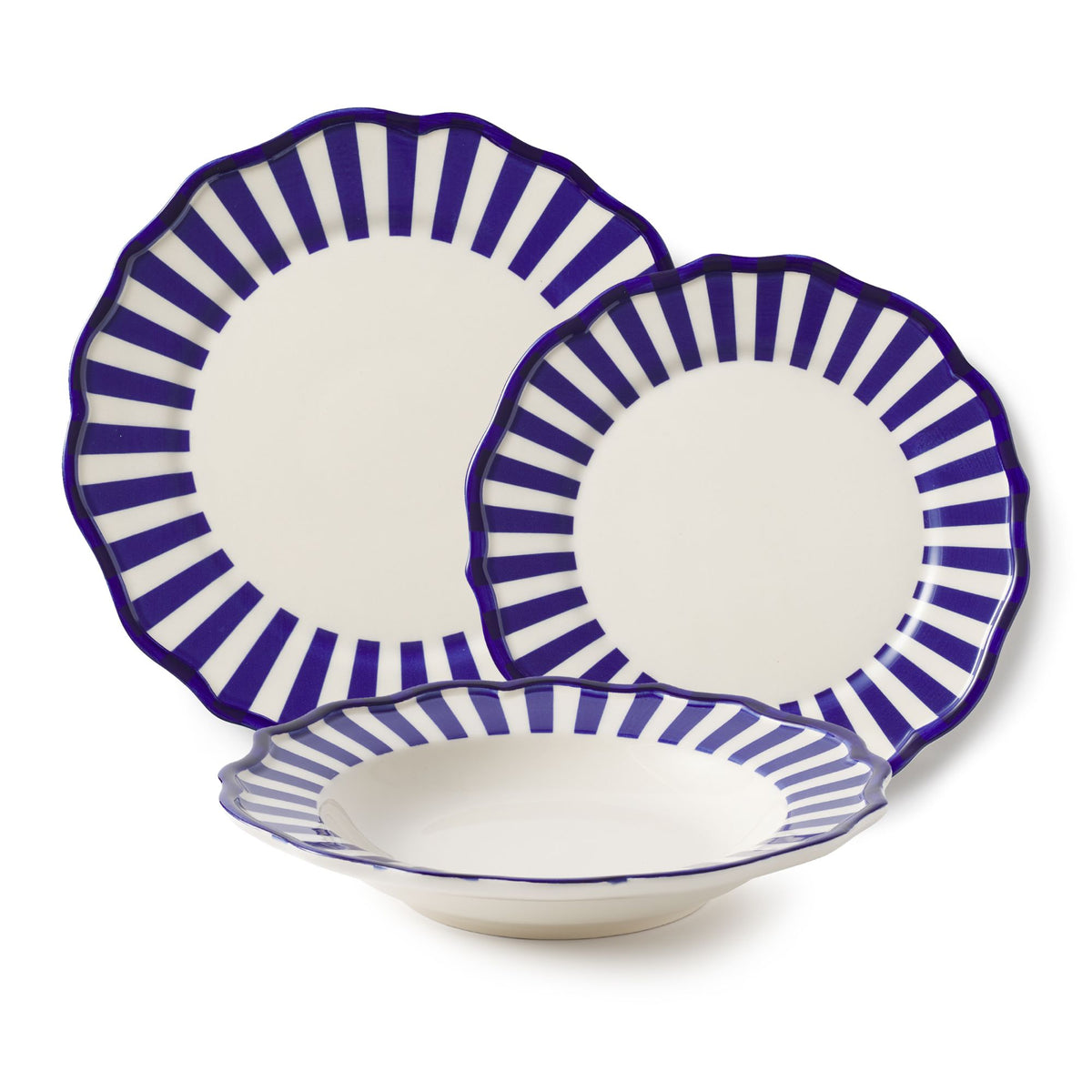 Front view of Riviera 12 piece dinnerware set with pasta bowl showcasing eclectic side plate and blue radial stripes on white backdrop