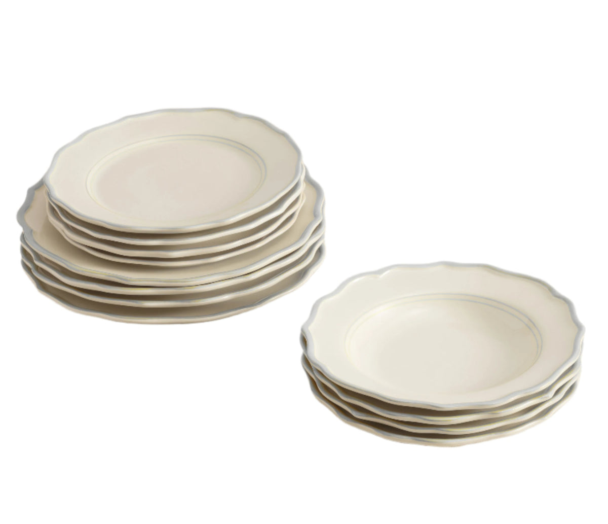 Angled view of Sylvia 12-piece ceramic dinnerware set with stacked plates and pasta bowls, scalloped rim, white background
