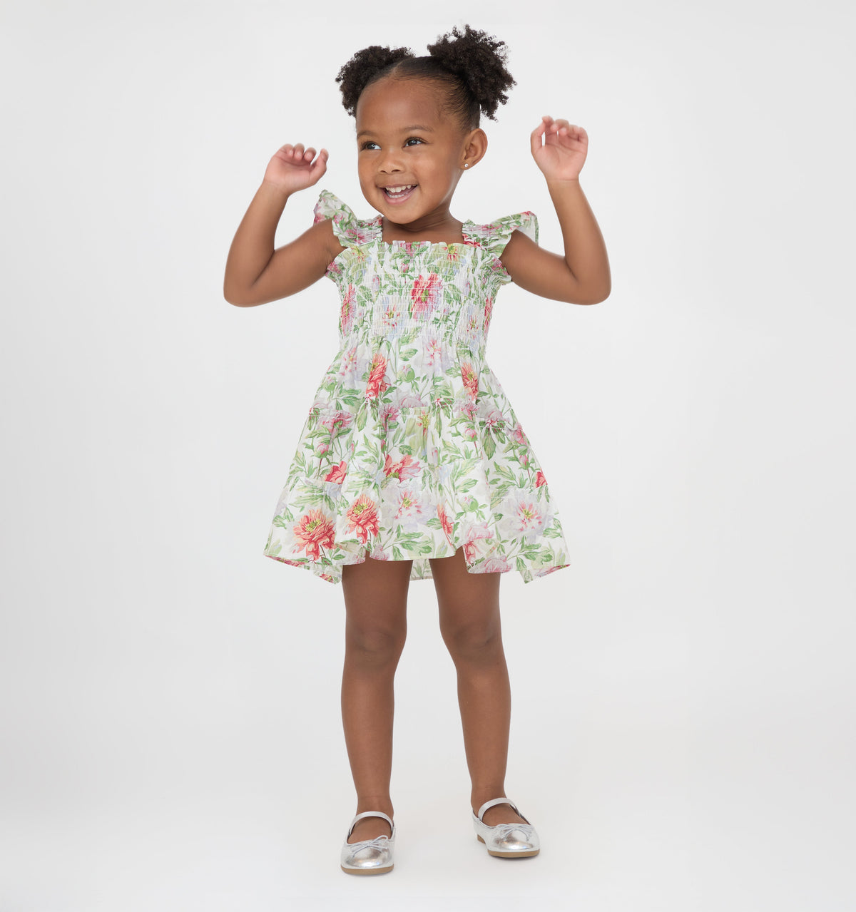 Front view of Tiny Ellie Nap Dress in Peony Chintz on child, showing smocked bodice, ruffled sleeves and A-line skirt