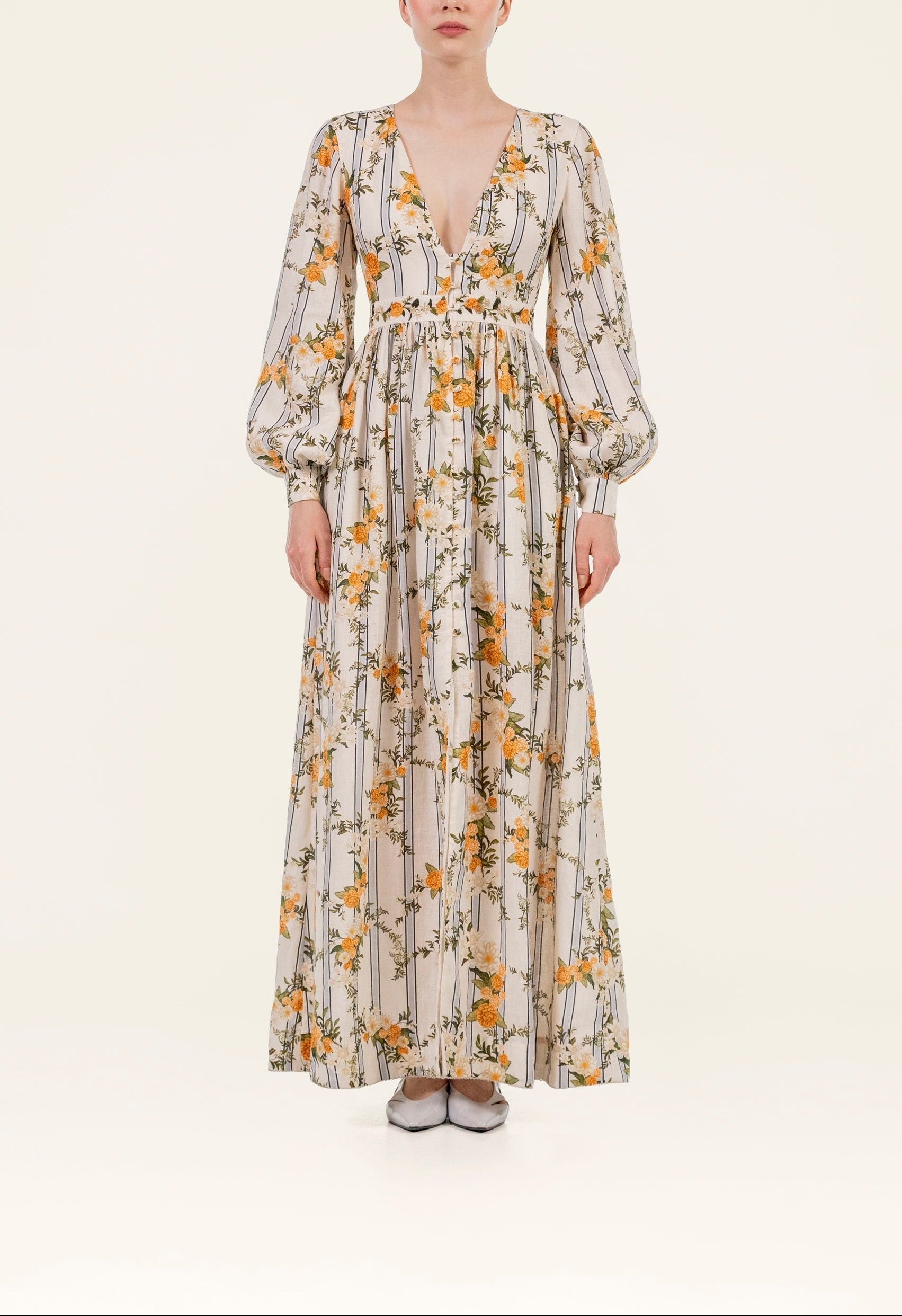 Front view of Frambuesa Valle Maxi Dress showcasing deep V-neck, puff sleeves, and yellow floral stripes on cream background