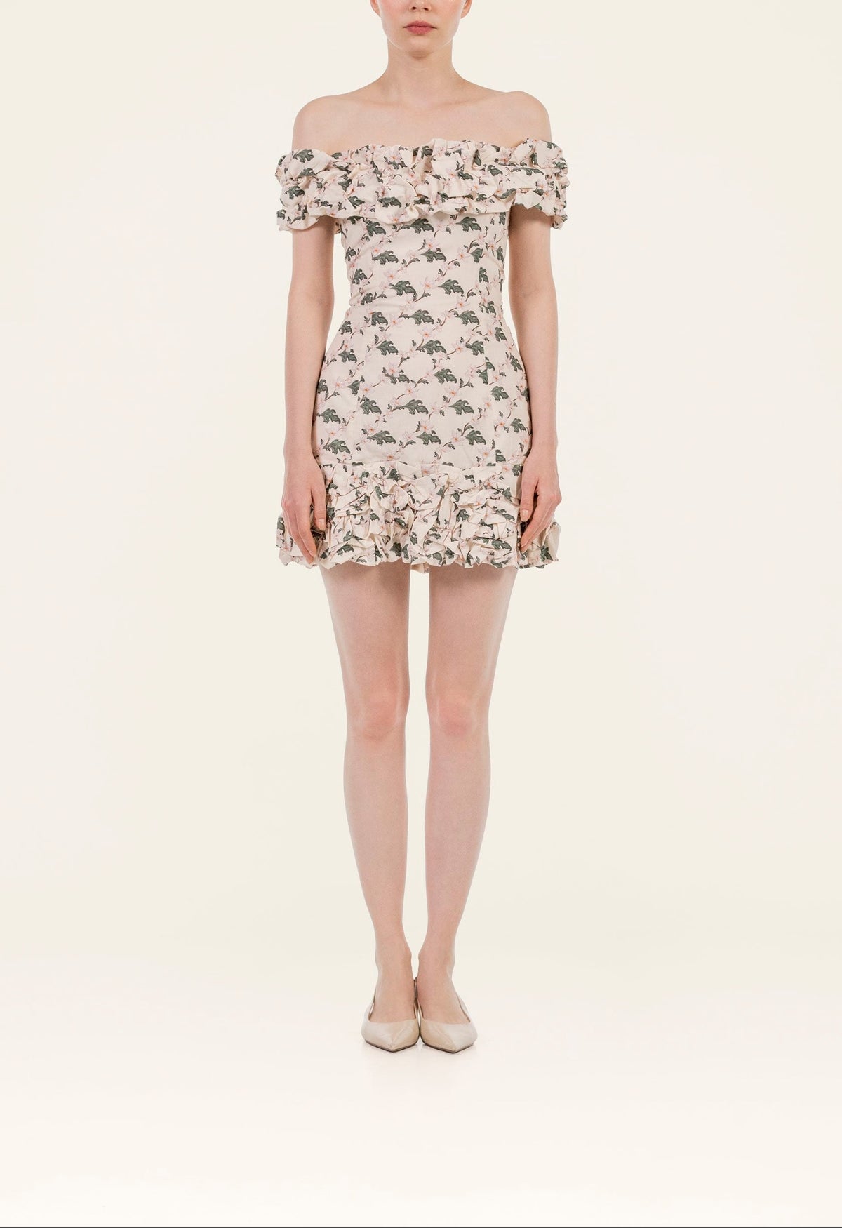 Front view of Jardin Anhelo mini dress on model showcasing off-shoulder ruffled neckline, fitted floral print and ruffle hem