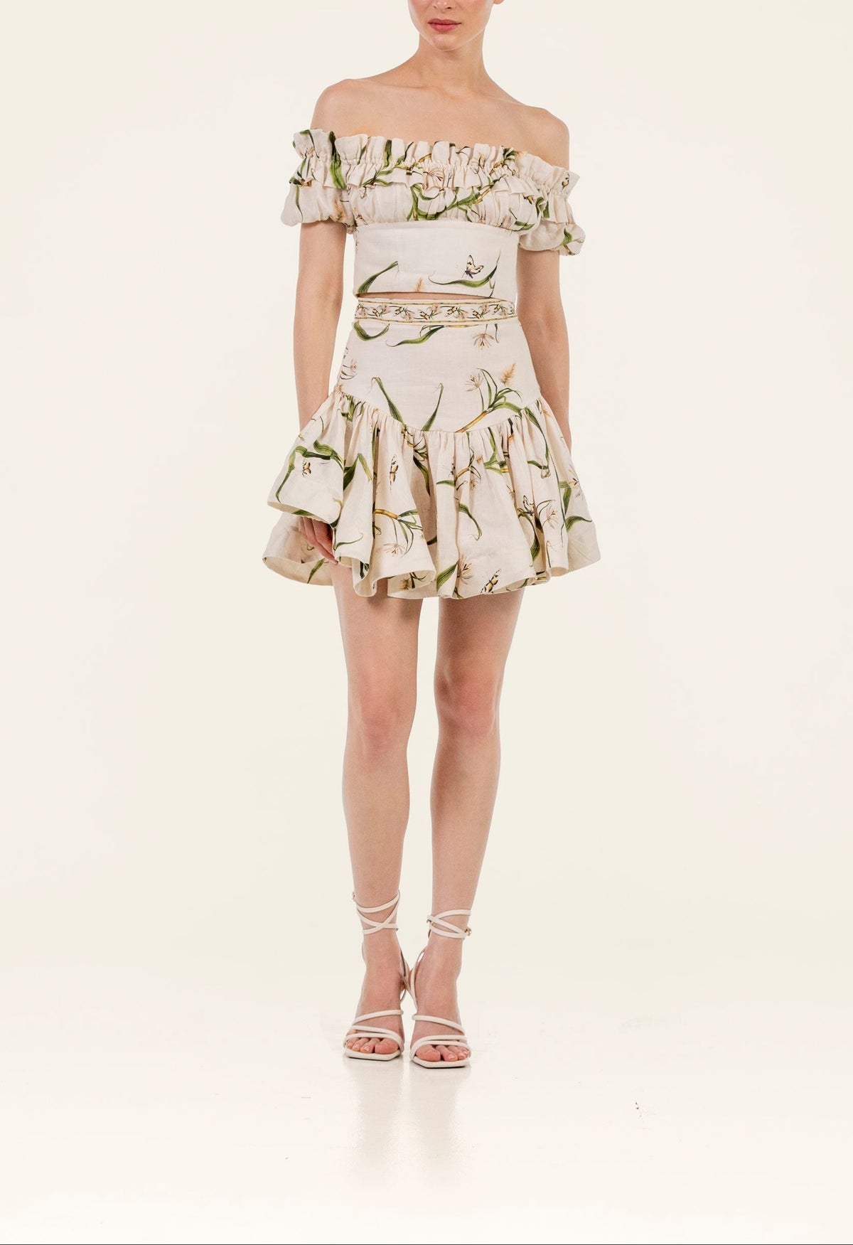 Front view of Pimienta Azucar Top on model showcasing off-the-shoulder neckline, hand-embroidered floral print and voluminous balloon sleeves on a pale studio background
