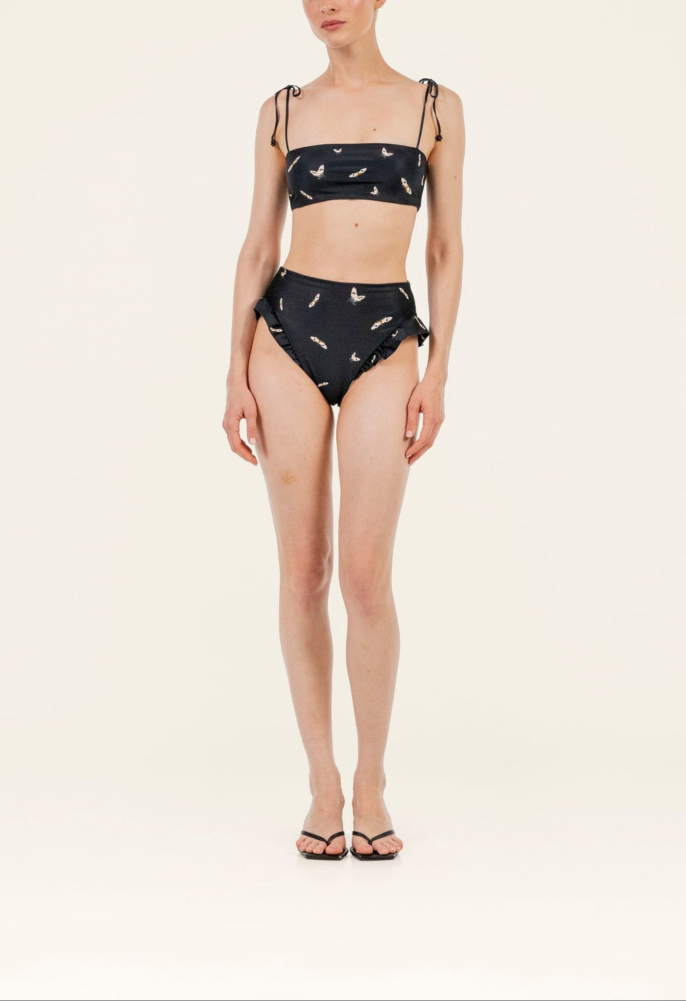 Front view of Primavera Azucar bikini top with tie shoulder straps and small butterfly print on light background