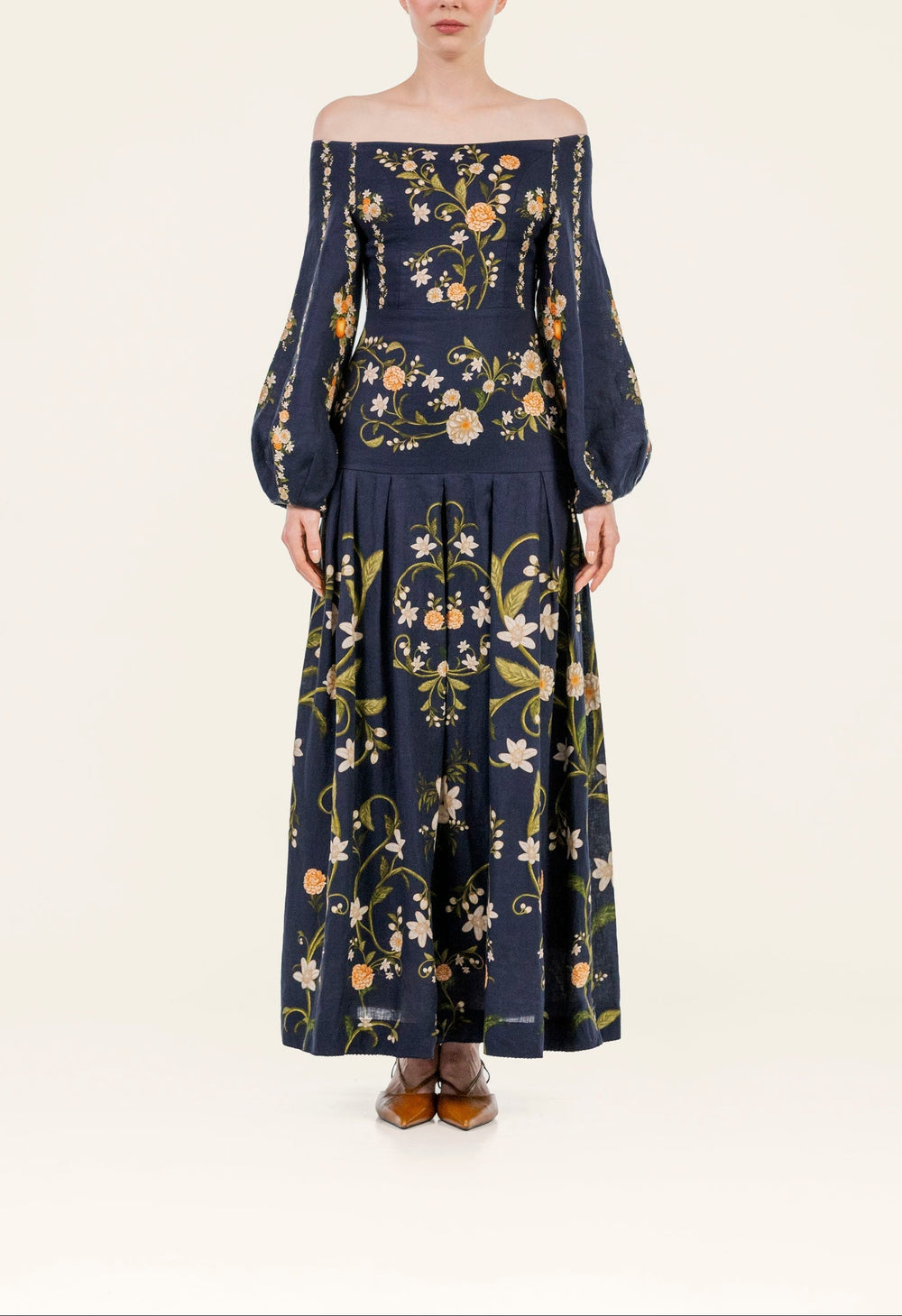 Front view of Senlis Valle maxi dress showcasing off-shoulder neckline, balloon sleeves, navy floral print on light background